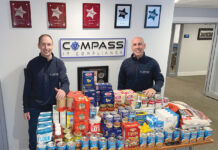 FEEDING THE NEEDY: Compass IT Compliance LLC employees donate food to the Blackstone Valley Emergency Food Center. / COURTESY COMPASS IT COMPLIANCE LLC