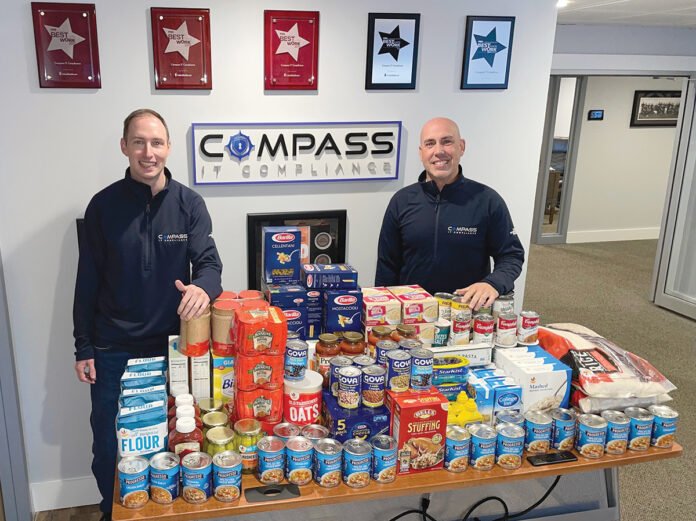 FEEDING THE NEEDY: Compass IT Compliance LLC employees donate food to the Blackstone Valley Emergency Food Center. / COURTESY COMPASS IT COMPLIANCE LLC FEEDING THE NEEDY: Compass IT Compliance LLC employees donate food to the Blackstone Valley Emergency Food Center. / COURTESY COMPASS IT COMPLIANCE LLC