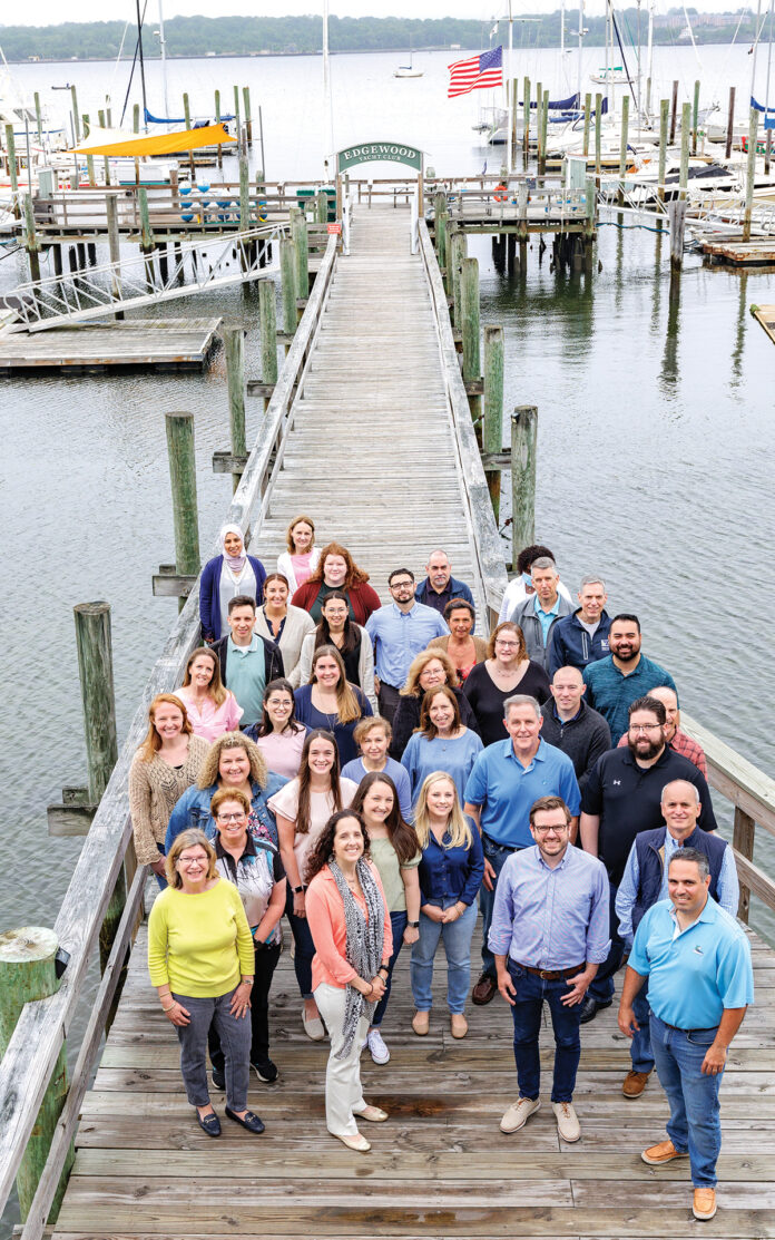 PEACEFUL RETREAT: Sansiveri, Kimball & Co. LLP team members enjoy their firm retreat at the Edgewood Yacht Club. / COURTESY SANSIVERI, KIMBALL & CO. LLP PEACEFUL RETREAT: Sansiveri, Kimball & Co. LLP team members enjoy their firm retreat at the Edgewood Yacht Club. / COURTESY SANSIVERI, KIMBALL & CO. LLP