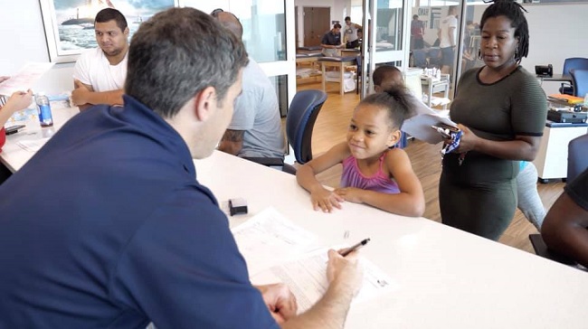 A UNIVERSITY ORTHOPEDICS INC. doctor checks students in for free pre-participation exams for fall sports in 2021. / COURTESY UNIVERSITY ORTHOPEDICS INC.