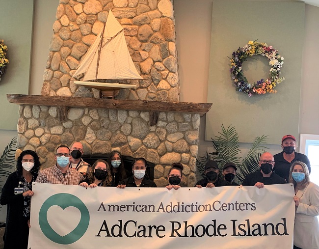 STAFF MEMBERS at AdCare Rhode Island show off the organization’s new logo. / COURTESY ADCARE RHODE ISLAND