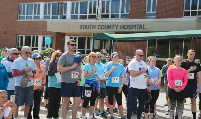 ON YOUR MARKS: South County Health employees assemble in front of South County Hospital in South Kingstown as they prepare to begin the South County Health Centennial 5K in May 2019.  COURTESY SOUTH COUNTY HEALTH