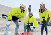 MOBILE PARTNER: From left, Gilbane Inc. Lead Superintendent Chris Pielech, construction intern Nick Shurling and project engineer Lauren Muldoon pose with an autonomous mobile robot.  COURTESY GILBANE INC.