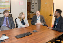 HEALTHY CONVERSATION: From left, Dr. Michael Coburn, medical director; Chief Operating Officer Sarah Horgan; Fred A. Trapassi Jr., CEO; and Courtney Stafford, director, clinical process improvement, at AdCare Rhode Island Inc. meet at the organization’s North Kingstown office. PBN PHOTO/TRACY JENKINS