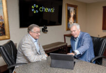 AVAILABLE OPTIONS: From left, First Circle Inc. CEO Joe Perroni and Blaine Carroll, president of First Circle and Chewsi RI, look over a tablet with the company’s new dentist search function.  PBN PHOTO/TRACY JENKINS