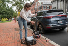 Are R.I.’s noises hurting health of our children? A SOUND MIND: Brown University research assistant Nina Lee demonstrates one of the noise monitors she installed at 140 locations around Rhode Island, from bustling cities to quiet rural communities. The ultimate goal is to establish a relationship between noise pollution and children’s health.
PBN PHOTO/MICHAEL SALERNO