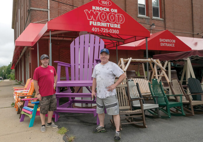 THE CHAIR MEN: Knock on Wood Furniture Inc. owner Michael Gordon, right, and his son Nathan Gordon, head of finishing operations, stand in front of the Lincoln furniture store and manufacturer.  PBN PHOTO/MICHAEL SALERNO
