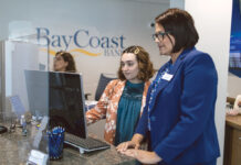 MONEY TALKS: Amy Hernandez, right, manager of BayCoast Bank’s downtown Providence branch on Dorrance Street, speaks with universal banker Bianca Gouveia.   PBN PHOTO/RUPERT WHITELEY