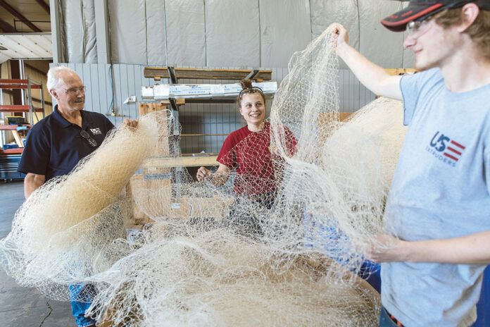 NOTHING BUT NET: From left, U.S. Extruders Inc. Plant Manager Wade Lippo and assemblers Lexus Falcone and Dan Brownhead work with fishing net.
PBN PHOTO/RUPERT WHITELEY NOTHING BUT NET: From left, U.S. Extruders Inc. Plant Manager Wade Lippo and assemblers Lexus Falcone and Dan Brownhead work with fishing net.
PBN PHOTO/RUPERT WHITELEY
