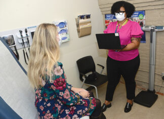 Mental health providers are overwhelmed in R.I. VITAL SERVICE: Ashlee Austin, right, site inclusive health clinician at Thundermist Health Center, meets with a patient at the
center’s West Warwick location.
PBN PHOTO/ELIZABETH GRAHAM