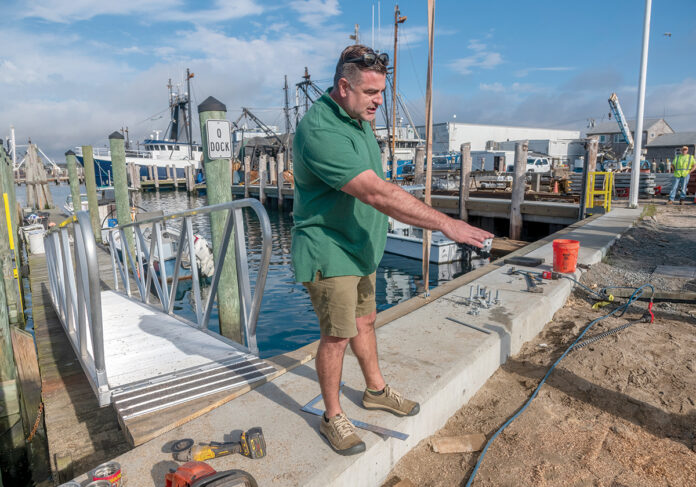 ON COURSE: Daniel Costa, Port of Galilee manager for the R.I. Department of Environmental Management, examines the improvements being made along the commercial waterfront at the port.  PBN PHOTO/­MICHAEL SALERNO