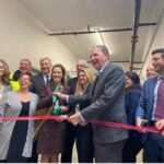 GOV. DANIEL J. MCKEE, center, helps with local state education and business officials cut the ribbon on the new Woonsocket Education Center. / COURTESY R.I. OFFICE OF GOV. DANIEL J. MCKEE