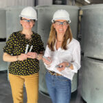FROM A TO ZINC: From left, Reade Advanced Materials Director of Marketing Elisabeth Reade Law and controller Amanda Reade Sturgeon hold a couple pieces of zinc while on a recent plant tour visiting zinc dust suppliers.  COURTESY READE  ADVANCED MATERIALS