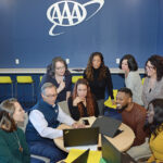 ADVANCING CAREERS: Staff members at AAA Northeast gather at the company’s Providence office. A year ago, AAA Northeast launched a career exploration program that provides a learning platform for employees of diverse backgrounds and talents who are performing well in their current roles. PBN PHOTO/ELIZABETH GRAHAM