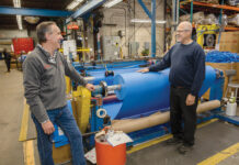 Cooley Group’s Dwight remains steadfast and willing to change to different climates RESILIENT WORKFORCE: Daniel Dwight, left, CEO and president of Cooley Group in Pawtucket, speaks with machine operator Henry DaSilva. Dwight says his core motivation is to inspire his team to maintain optimism in the face of an ever-changing environment.
PBN PHOTO/TRACY JENKINS