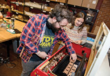 Katrinkles Inc. gets crafty about helping the environment WHIMSICAL PRODUCTS: Katy Westscott, CEO of Katrinkles Inc. in Providence, which makes buttons and tools for crafters, goes over some of the company’s products with production technician Brandon Amorin.
PBN PHOTO/TRACY JENKINS