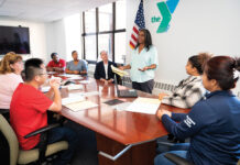 YMCA of Greater Providence has been a community anchor for more than a century UNITED: YMCA of Greater Providence Assistant Director of Diversity, Equity and Inclusion Kira Wills, standing, addresses her colleagues at the organization’s Providence office. Wills says the YMCA is for all, which is reflected by its staff being comprised of individuals who are neurodivergent, have disabilities, speak multiple languages, identify as LGBTQIA and are different ages.
PBN PHOTO/DAVID HANSEN