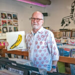 RARE FIND: In Your Ear Records owner Chris Zingg holds a 1967 pressing of “The Velvet Underground & Nico” at the record store’s recently opened second location in Warren at 99 Water St., which specializes in rarities and high-end records. PBN PHOTO/MICHAEL SALERNO