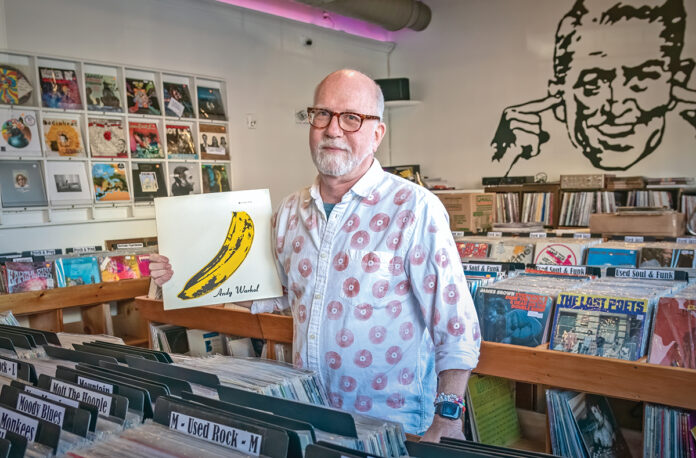 RARE FIND: In Your Ear Records owner Chris Zingg holds a 1967 pressing of “The Velvet Underground & Nico” at the record store’s recently opened second location in Warren at 99 Water St., which specializes in rarities and high-end records. PBN PHOTO/MICHAEL SALERNO