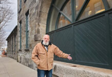 Brown’s land of opportunity: University’s expansion is welcomed but is school paying its fair share? NEIGHBORHOOD PRIDE: Olin Thompson, a Jewelry District resident and amateur historian, points to the architectural features on a stone building at 110 Elm St. that was once a foundry and is now leased by Brown University for administrative and medical offices.
PBN PHOTO/CLAUDIA CHIAPPA