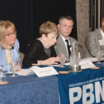 EASING OUTLOOK: Panelists discuss the official end to the COVID-19 national emergency at PBN’s Spring 2023 Health Care Summit on April 6. On the panel, from left, are Kristine Campagna of the R.I. Department of Health; Jane Hayward of the Rhode Island Foundation’s Long-Term Health Planning Committee; Corey McCarty of CCA Health Rhode Island; and Dr. G. Dean Roye of Rhode Island Hospital.   PBN PHOTO/MIKE SKORSKI