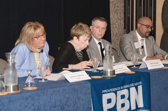 EASING OUTLOOK: Panelists discuss the official end to the COVID-19 national emergency at PBN’s Spring 2023 Health Care Summit on April 6. On the panel, from left, are Kristine Campagna of the R.I. Department of Health; Jane Hayward of the Rhode Island Foundation’s Long-Term Health Planning Committee; Corey McCarty of CCA Health Rhode Island; and Dr. G. Dean Roye of Rhode Island Hospital.   PBN PHOTO/MIKE SKORSKI