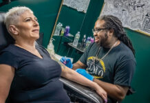 Everybody’s Business: Determined to leave his mark on community REPEAT CUSTOMER: Joseph Becton, owner of F.I.N.A.O. Tattoo Ink in North Providence, designs an extension for Donna Ruggieri of West Warwick, who said Becton took very good care of her previous tattoo.
PBN PHOTO/MICHAEL SALERNO