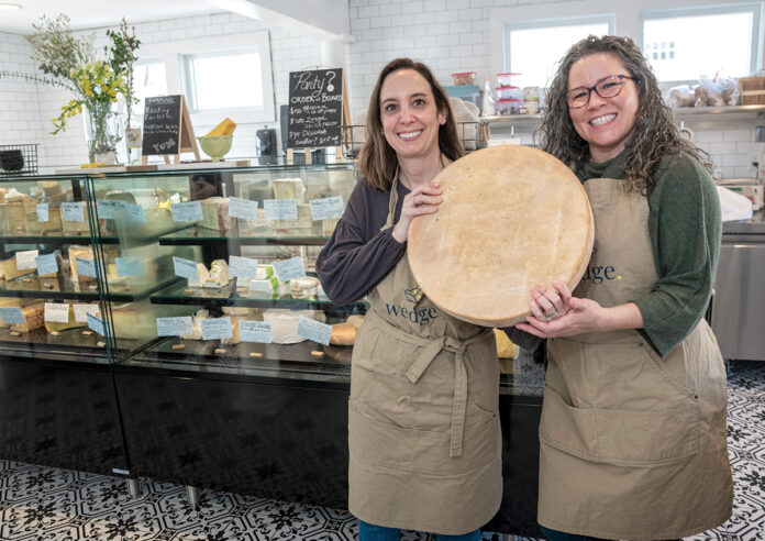 FILLING A VOID: Wedge co-owners Sasha Goldman, left, and Chelsea Morrissey opened their cheese shop in Warren after noticing limited artisan cheese options in the area.  PBN PHOTO/MICHAEL SALERNO