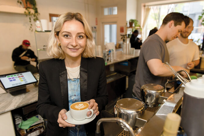 STEADY GROWTH: Audrey Finocchiaro, co-owner of The Nitro Bar, has taken her coffee business from a simple cart in 2016 to now preparing to open her fourth location in June, in Little Compton. At right is Coffee Director Nick Berry at the Providence shop. PBN PHOTO/TRACY JENKINS