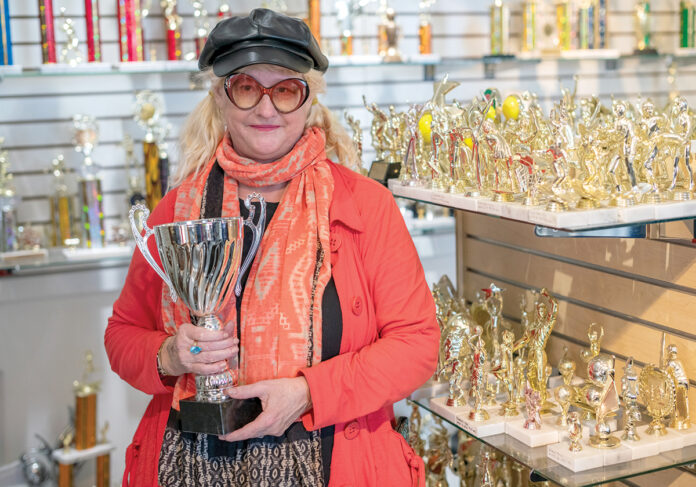 REWARDING JOB: Kristen Gossler, president of American Trophy and Supply Inc., has expanded the business with her husband, Peter Cameron, since buying it from her parents in 1990.  PBN FILE PHOTO/MICHAEL SALERNO