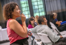 HELPING OUT: Shirley Moore, left, owner of Be Moore Interpreting LLC in Pawtucket, provides interpreting services for the attendees at the Latino Financial Summit at Farm Fresh in Providence.  PBN FILE PHOTO/MICHAEL SALERNO
