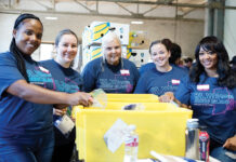 Blue Cross & Blue Shield of Rhode Island TRUE BLUE: Blue Cross & Blue Shield of Rhode Island volunteers sort donations at the Rhode Island Community Food Bank during the company’s 11th annual Blue Across Rhode Island day of service.
COURTESY BLUE CROSS & BLUE SHIELD OF RHODE ISLAND