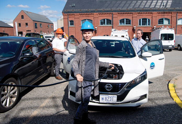 ELECTRIFIED: Staffers at the Narragansett Bay Commission charge an electric vehicle as part of its commitment to renewable energy.  COURTESY NARRAGANSETT BAY COMMISSION