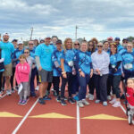 SUPPORTING ANTHONY: Westerly Community Credit Union employees participate in a Belly Button 5K Walk, an event created by one of its employees and his wife in memory of their son, Anthony, who died due to a rare birth defect.  COURTESY WESTERLY COMMUNITY CREDIT UNION