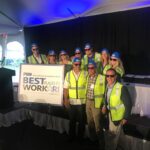 PARISEAULT BUILDERS INC. employees dressed in construction attire pose for a photo Wednesday during Providence Business News' Best Places to Work Awards ceremony at the Crowne Plaza Providence-Warwick. / PBN PHOTO/JAMES BESSETTE