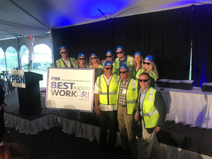 PARISEAULT BUILDERS INC. employees dressed in construction attire pose for a photo Wednesday during Providence Business News' Best Places to Work Awards ceremony at the Crowne Plaza Providence-Warwick. / PBN PHOTO/JAMES BESSETTE