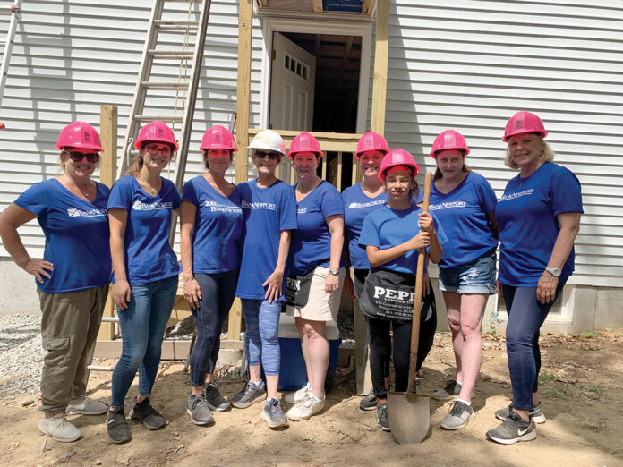 BUILDING A FUTURE: BankNewport employees help construct a home for Habitat for Humanity.  COURTESY BANKNEWPORT