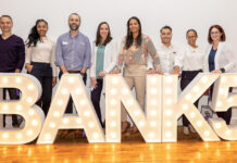 Fall River Five Cents Savings Bank SHINING BRIGHTLY: Fall River Five Cents Savings Bank employees pose behind a lighted sign of the bank’s name.
COURTESY FALL RIVER FIVE CENTS SAVINGS BANK
