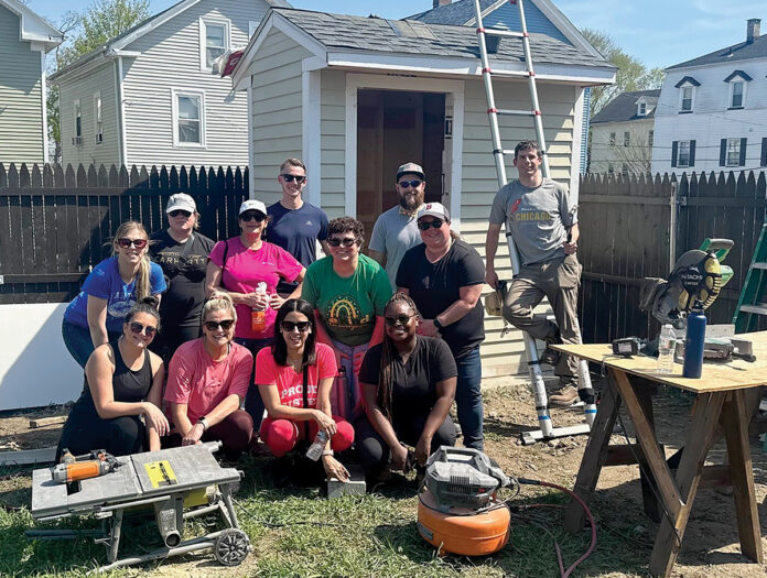 TRAINING DAY: The New England Construction team poses for a photo before one of its team trainings in 2022. Last year, the company offered 27 programs for its employees to support their professional development.  COURTESY NEW ENGLAND CONSTRUCTION