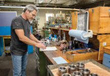 THE DAILY GRIND: Family-owned Tracey Gear machines parts for clients ranging from Disney to NASA FOR GOOD MEASURE: Machinist Dennis Sullivan checks his calculation on an order of spur gears Tracey Gear has just made for a food processing company.
PBN PHOTO/TRACY JENKINS