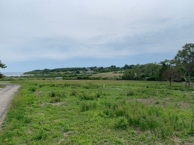 A 2.25-ACRE PROPERTY consisting of two conjoining lots located next to the ocean at 19 Beach Drive and 21 Beach Drive in Little Compton recently sold for $1.8 million, making it the largest vacant land sale in the town since 2021. / COURTESY MOTT & CHACE SOTHEBY'S INTERNATIONAL REALTY