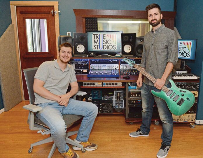DYNAMIC DUO: True Music Studios owner Nolan Quartaroli, right, launched the audio production studio in 2011 in Smithfield. He recently promoted audio engineer and producer Nick Lancellotti, left, to business partner after Lancellotti helped him keep the business going during the pandemic. PBN PHOTO/ELIZABETH GRAHAM 