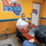 ALL-SPANISH STATIONS: Tony Mendez, background, owner of Poder 1110 AM and Power 102.1 FM, the longest-serving Hispanic radio stations in Rhode Island, speaks with Zoilo Garcia, program director and morning show host. PBN PHOTO/MICHAEL SALERNO
