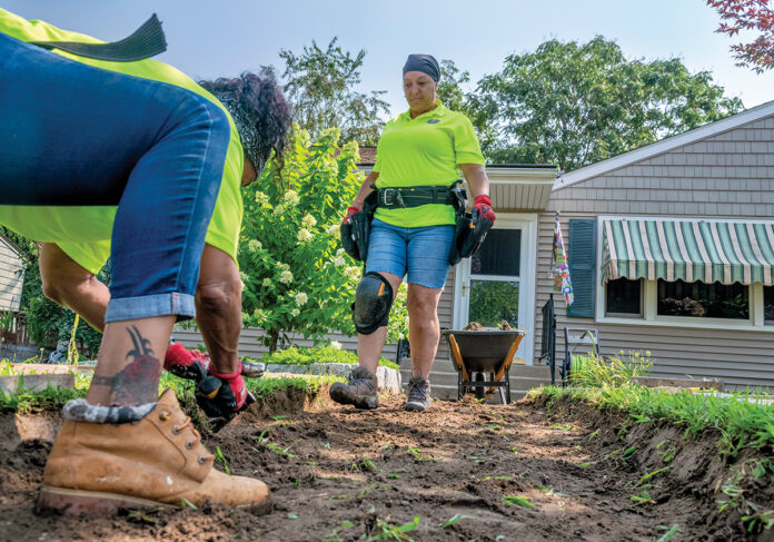 WORKING TOGETHER: Anita Bruno, right, executive director of Rhode Island Women In The Trades, and Jessica Baez, pre-apprentice, work on a construction site at a home in Cranston. PBN PHOTO/MICHAEL SALERNO