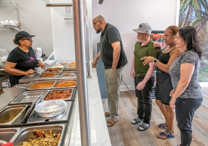 AT YOUR SERVICE: Edy Cruz, third from the right, and his wife, Zuleyka Gardinet, second from right, mingle with customers at Cruz’s restaurant El Anafe on Manton Avenue in Providence. From left are server Eva Baaz, Edgar Schultz, Cruz, Gardinet and Alba Martinez.
PBN PHOTO/MICHAEL SALERNO AT YOUR SERVICE: Edy Cruz, third from the right, and his wife, Zuleyka Gardinet, second from right, mingle with customers at Cruz’s restaurant El Anafe on Manton Avenue in Providence. From left are server Eva Baaz, Edgar Schultz, Cruz, Gardinet and Alba Martinez.
PBN PHOTO/MICHAEL SALERNO
