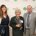 FAMED SCOUT: Nancy Armstrong, center, is presented with the inaugural Hall of Fame award from the Girl Scouts of Southeastern New England. Pictured with Armstrong are Girl Scouts CEO Dana Borrelli-Murray, left, and Girl Scouts Director of Properties and Facilities William Webster.  COURTESY GIRL SCOUTS OF  SOUTHEASTERN NEW ENGLAND