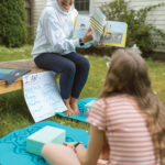 ONE-ON-ONE: Jenny Gaynor, owner of Calm Education, reads to her daughter, Ella. Gaynor coaches kids in social and emotional learning.  PBN PHOTO/RUPERT WHITELEY