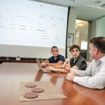 SIMPLIFYING SHIPPING: From left, interns Jackson Foscaldo and Dylan Jones, and Jason Kelly, executive vice president of Moran Shipping Agencies Inc. and co-founder of Attender Inc. The company is using an artificial intelligence engine to support the procurement process  for the maritime  services agency.  PBN FILE PHOTO/ MICHAEL SALERNO