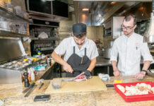 FISH FILET: William Bangs, right, executive sous chef at The Chanler at Cliff Walk in Newport, observes as demi sous chef Nicolas Rizzo ­prepares a black sea bass. PBN PHOTO/MICHAEL SALERNO