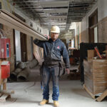 HANDS-ON LEARNING: ­Chandler ­Architectural ­Products carpenter apprentice Luis ­Mercedes at the former Windmill Street Elementary School building in Providence, which is undergoing renovation.   PBN PHOTO/ELIZABETH GRAHAM